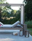 An LJ Solar Lantern SKAAL Tink121 Large 500L Duratek daybed adorned with pillows, creating an outdoor oasis on a wooden deck.