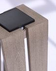 A wooden table with the LJ Solar Lantern SKAAL Tink121 Large 500L Duratek by Les Jardins on top, exuding an organic charm and transforming any outdoor space into a serene oasis.