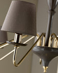 The Lorenzon Divina Chandelier showcases timeless elegance with its gold design and Italian craftsmanship, accentuated by a grey shade.