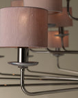 The Lorenzon Divina Chandelier exudes timeless elegance with its Italian craftsmanship and several shades of pink hanging from it.
