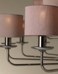 The Lorenzon Divina Chandelier exudes timeless elegance with its Italian craftsmanship and several shades of pink hanging from it.