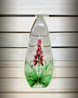 Maleras Crystal Sculpture Orchid Red on a wood background, available at Spacio India from the Sculptures and Art Objects Collection