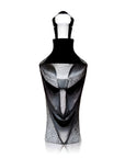 A face shaped crystal decanter on a gray background from Maleras, available at Spacio in India.