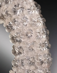 Close-up of a floral-patterned Murano mirror against a dark background