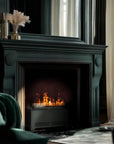 Cozy living room with a lit artificial water vapour fireplace, green armchair, and decorative elements.