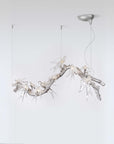 Modern chandelier with branch-like design on a white background