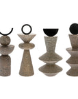 Set of four stone decorative objects with black circular elements on a white background