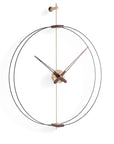 A Clock Nomon Barcelona Mini Gold MBARG by Nomon with a circular shape hanging on a wall.