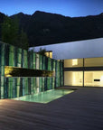 Modern house with a pool and bamboo wall at night
