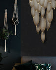 A luxurious living room adorned with an elegant Meystyle Dolomite Chandelier hanging on the wall.