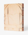 Back slip cover in linen. Burberry coffee table book by Assouline, celebrating 165 years of British style, iconic trench coats, and timeless luxury through stunning illustrations and stories.