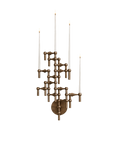 A multi-tiered brass wall sconce with five candle-style arms and three lit taper candles, isolated on a white background.