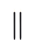 Two black mini ultra slim taper candles with led flames, standing upright against a plain white background by Uyuni available at Spacio in India.