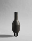 Description: A 101Cph Duck Slim Coffee 111280 vase on a grey background. Brand Name: 101 Copenhagen