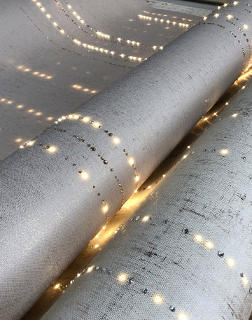 A large roll of Conductivity LED Wallpaper with Swarovski embedded with LED lights showcasing conductivity and electricity by Meystyle.
