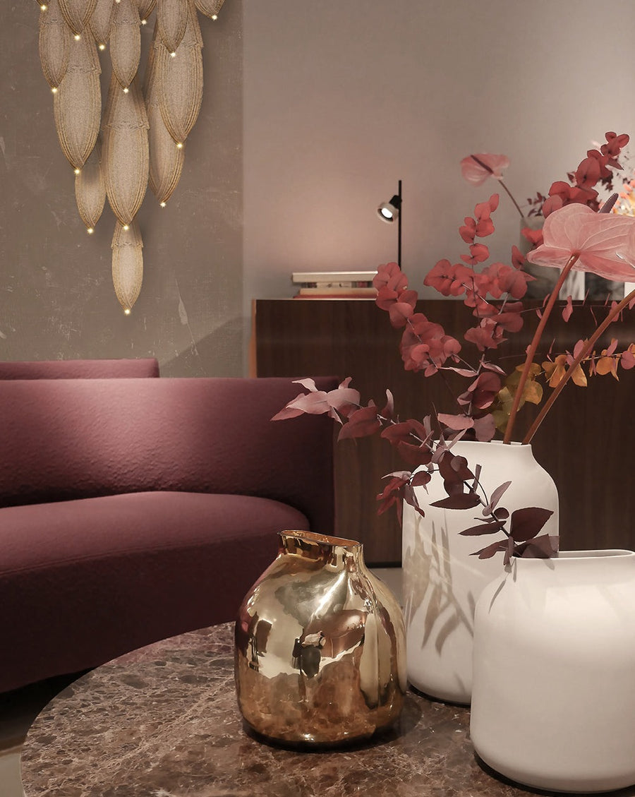 A living room with elegant furniture, including a Meystyle Dolomite LED Wall Paper couch and two exquisite vases.