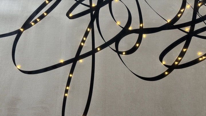 Elegant interior styled with Meystyle’s wallpaper with light, where illuminated script and crystal inlays bring a poetic ambiance to the space.