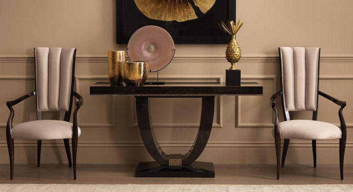 Classic entrance foyer setup with dark wood console, gold accents, designer chairs, and wall art – elegant styling solutions from Spacio India.