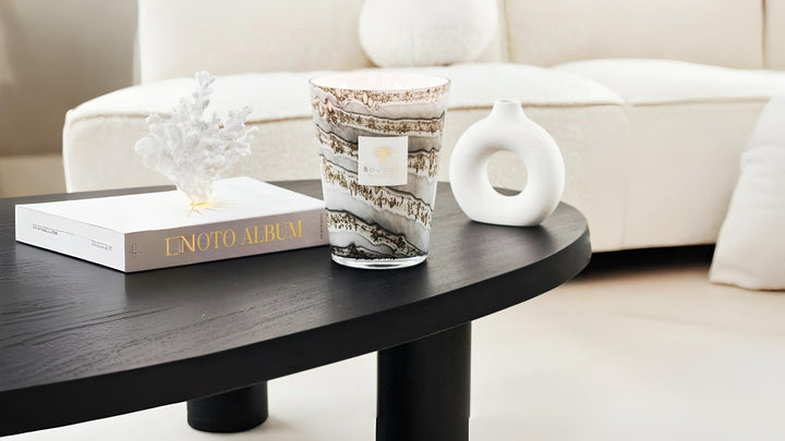 Close-up of Baobab diffuser in a sunlit modern interior with a golden crab figurine, styled on a wooden coffee table.