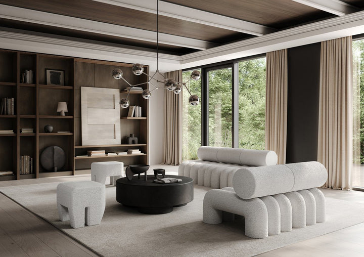101 Copenhagen sculptural boucle sofas and stools with round coffee table in a modern living room by Spacio
