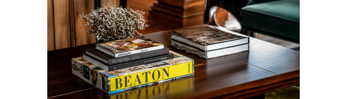 Coffee table books styled with premium home decor accessories in a luxury living room