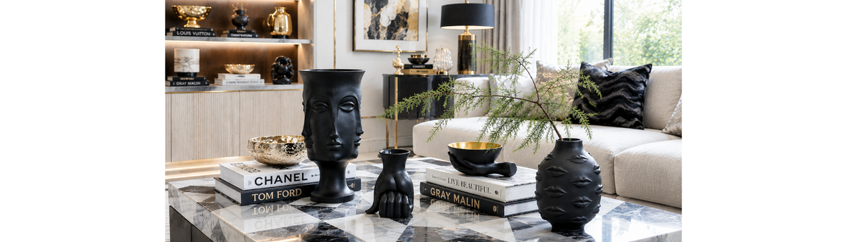Luxury home decor objects and sculptural vases styled in an elegant living room
