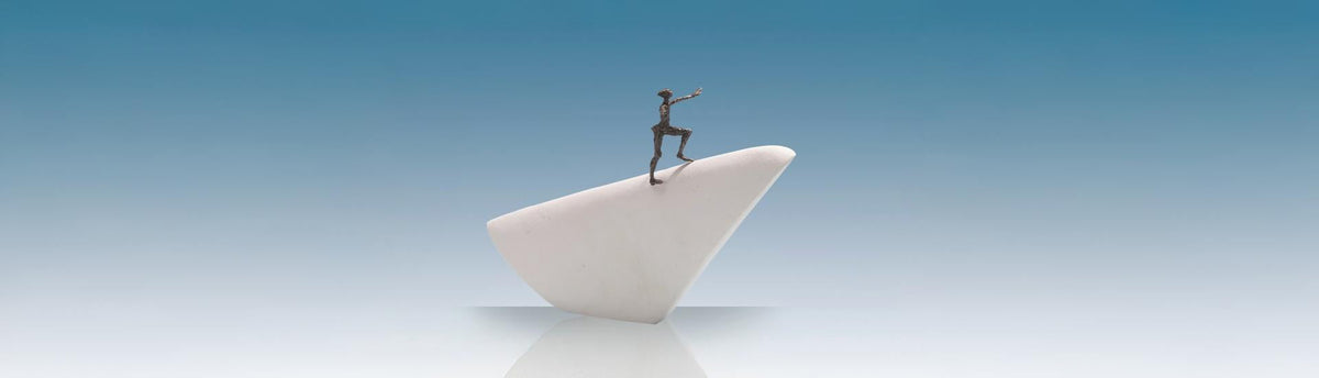 Abstract business sculpture showing a figure leaping between two stone pillars, symbolising courage and bold decision-making.