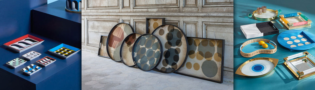 Collage of decorative and serving trays in ceramic, wood and glass. 