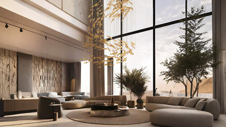 A luxurious living room with double-height ceilings, showcasing a fluid sculptural light installation made of golden suspended elements, creating a floating effect above a circular coffee table and modern seating.