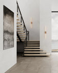 Modern staircase with black railing in a minimalistic interior setting.