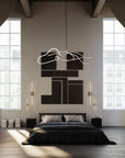 Modern bedroom with a stylish chandelier, bed, and wall art.
