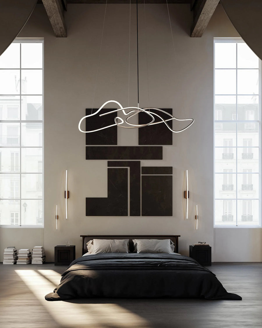 Modern bedroom with a stylish chandelier, bed, and wall art.