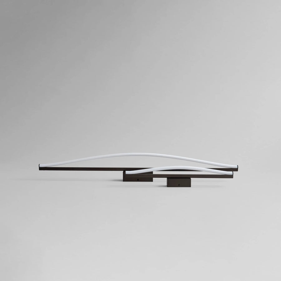 Modern wall-mounted light fixture on a gray background