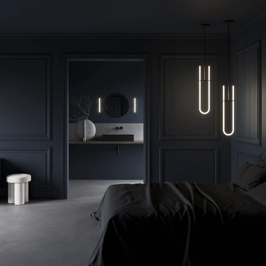 Modern bedroom with dark walls, a bed, and minimal decor.