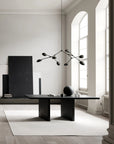 A Scandinavian theme dining room styled with wall art, sculptural vase, wall art and a minimal design chandelier. 