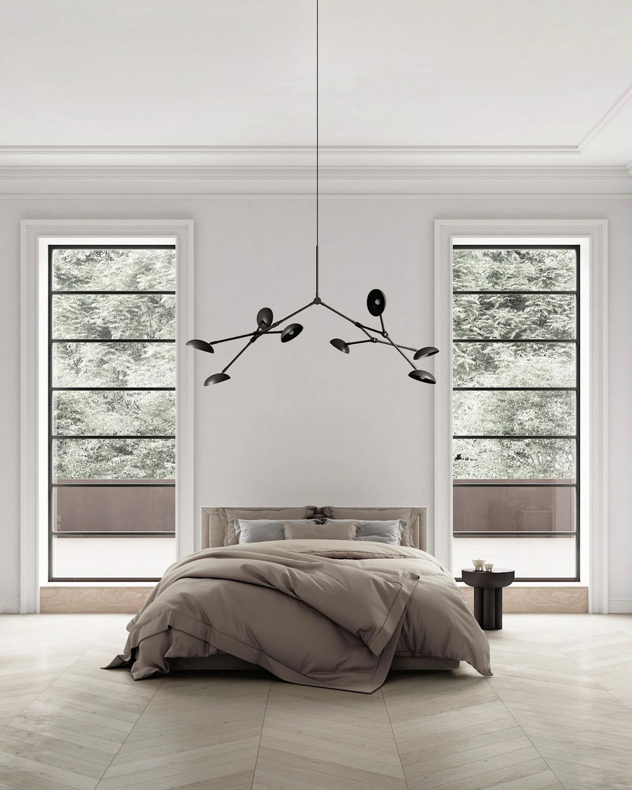 A Wabi Sabi theme bedroom interior with a minimal chandelier hanging from the ceiling. 