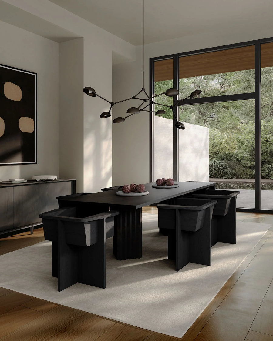 A Scandinavian theme dining room styled with wall art, sculptural vases , bowl, wall art and a minimal design chandelier. 