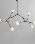 Modern chandelier with white spherical lights on a gray background