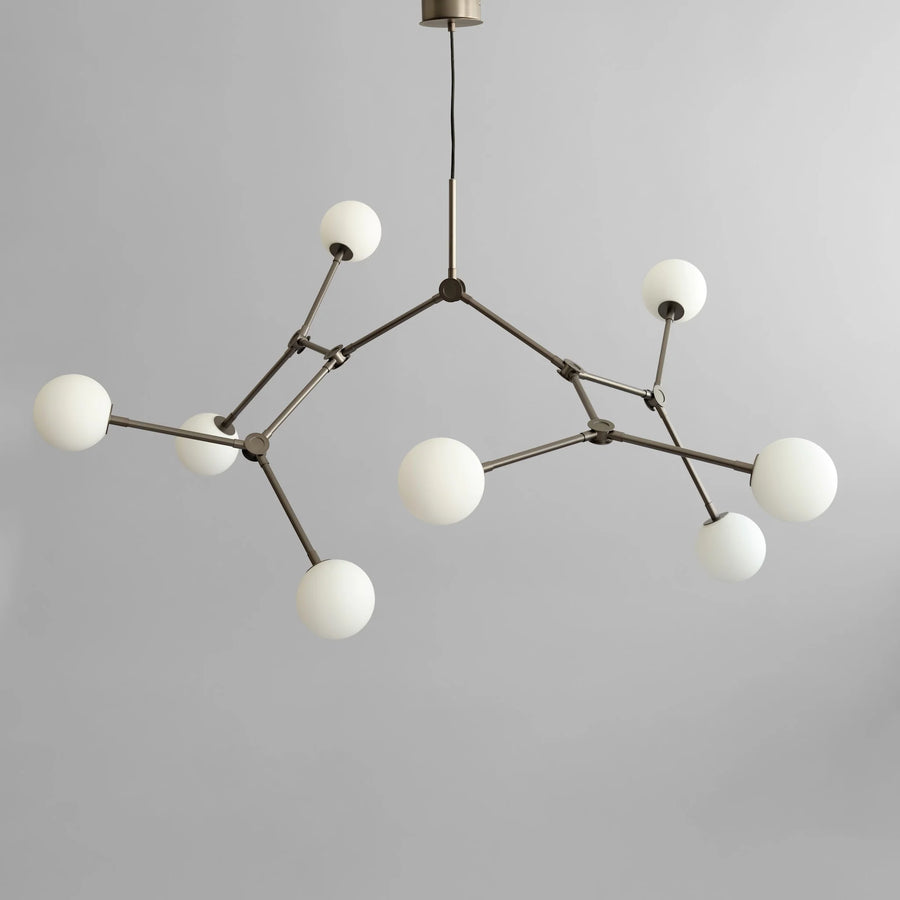 Modern chandelier with white spherical lights on a gray background