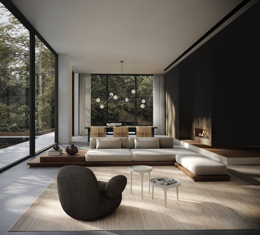 Modern living room with a large sectional sofa, coffee table, and decorative items.