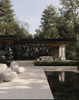 Modern outdoor living space with a pool, lounge chairs, and wooden deck.