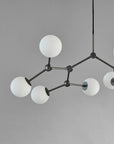 Modern chandelier with white spherical lights on a gray background