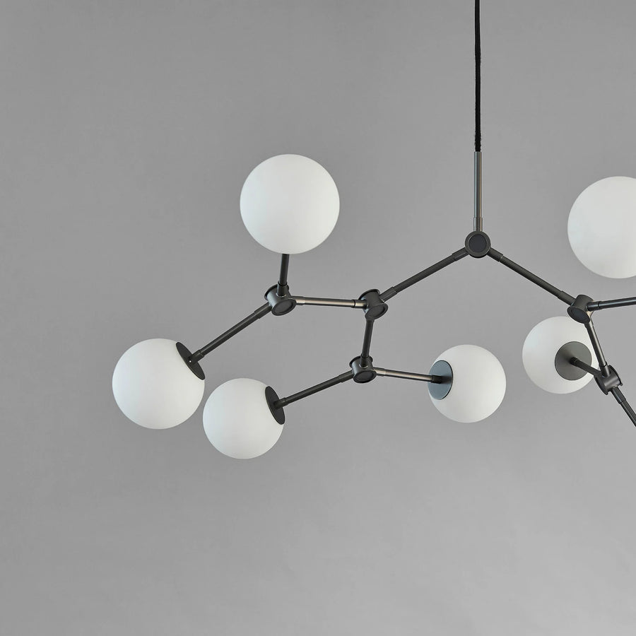 Modern chandelier with white spherical lights on a gray background