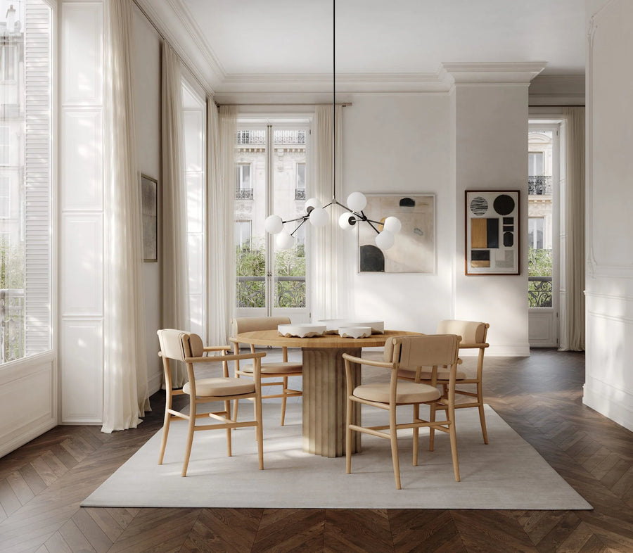 Modern dining room with wooden table and chairs, large windows, and minimal decor.
