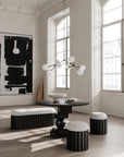 Modern interior with black and white furniture and abstract art.