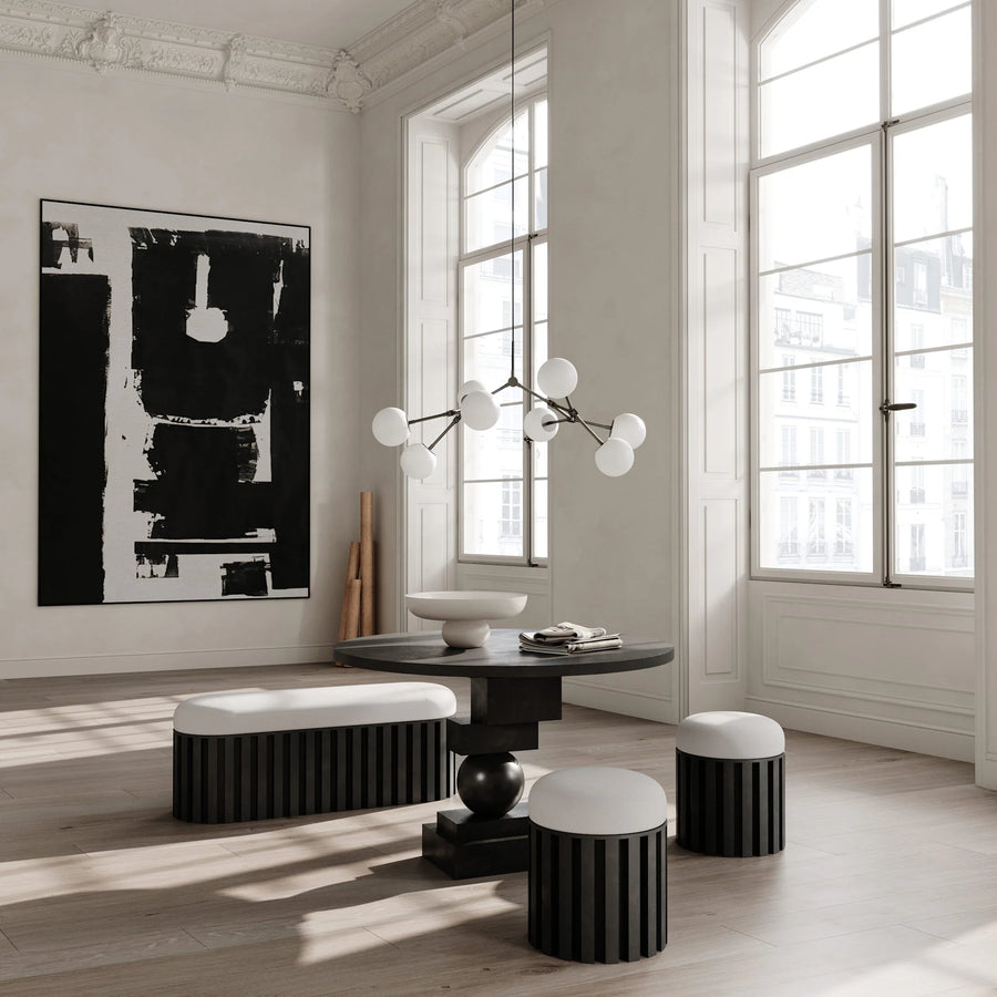 Modern interior with black and white furniture and abstract art.