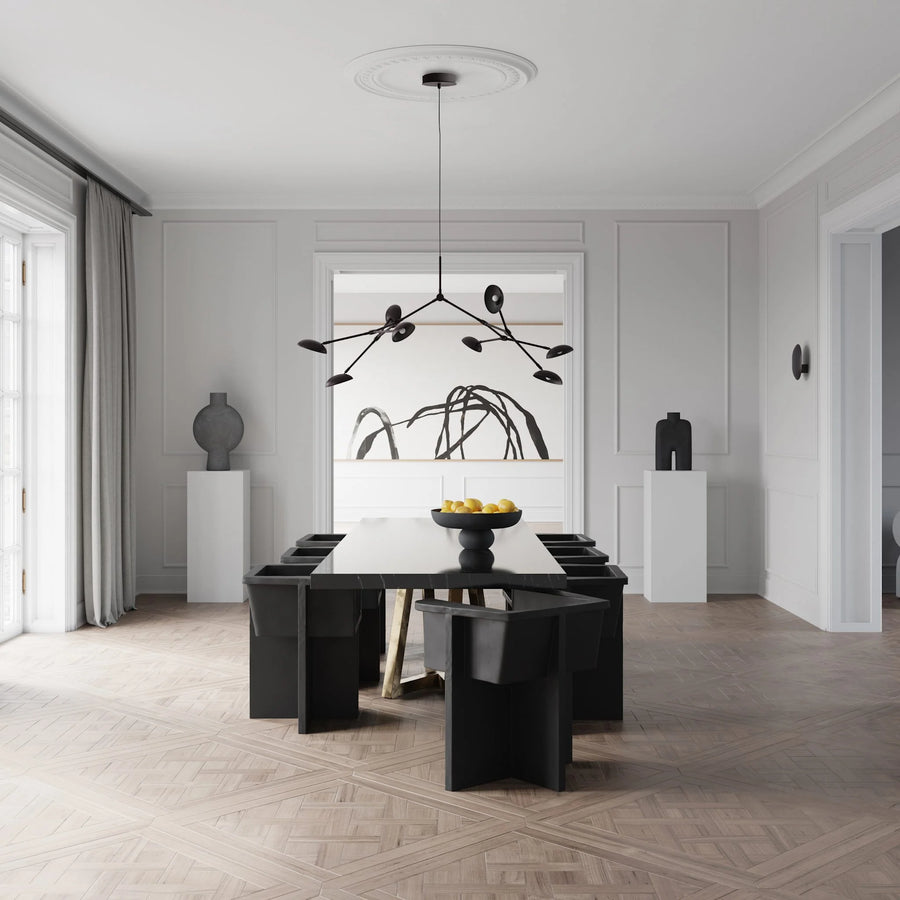 A Scandinavian theme dining room styled with wall art, sculptural vases , bowl, wall art and a minimal design chandelier. 