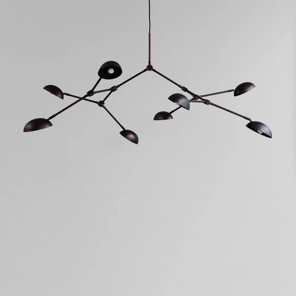 A modern design chandelier with 8 arms on a plain grey background from 101 Copenhagen available at Spacio retail stores in Mumbai & Kolkata. 