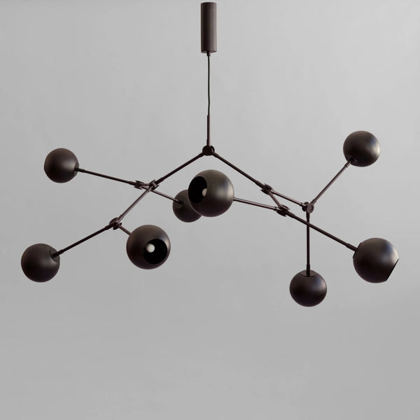 Modern black chandelier against a gray background from 101 Copenhagen available at Spacio retail stores in Mumbai & Kolkata. 