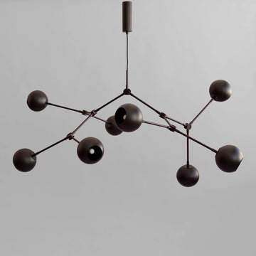 Modern black chandelier against a gray background from 101 Copenhagen available at Spacio retail stores in Mumbai & Kolkata. 